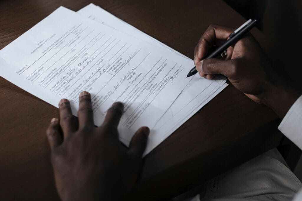 man signing documents